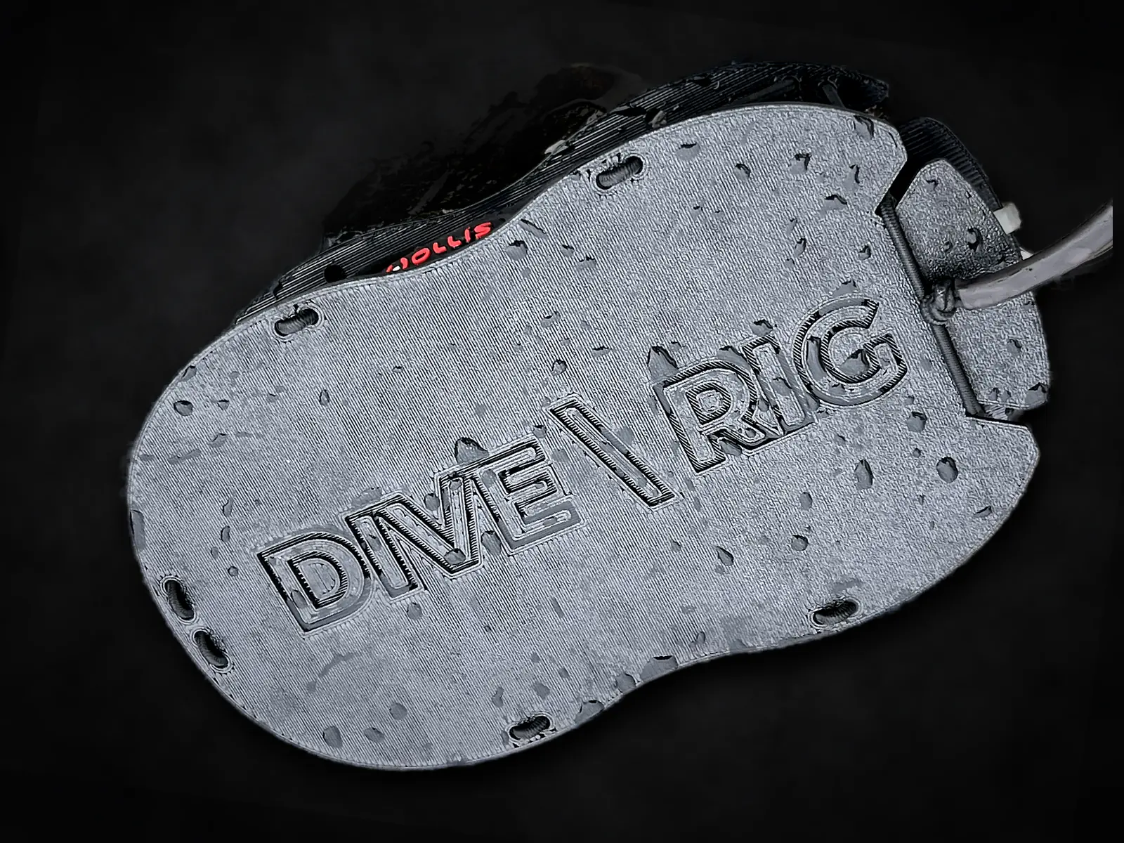 MaskDock™ from above — embossed DIVE\RIG logo, bungee eyelets around the plate