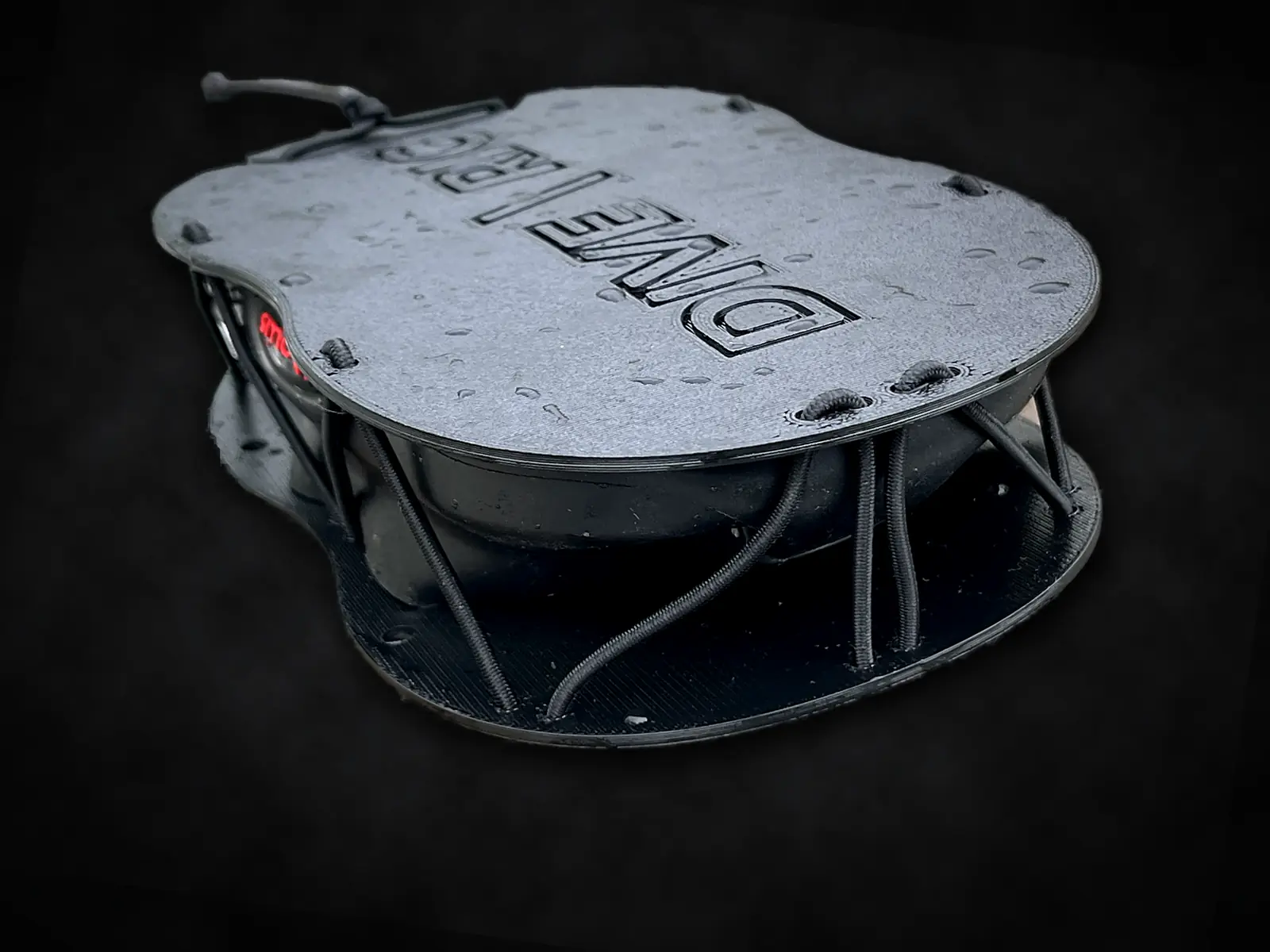 MaskDock™ side view — the bungee cage holding a backup mask between the two plates